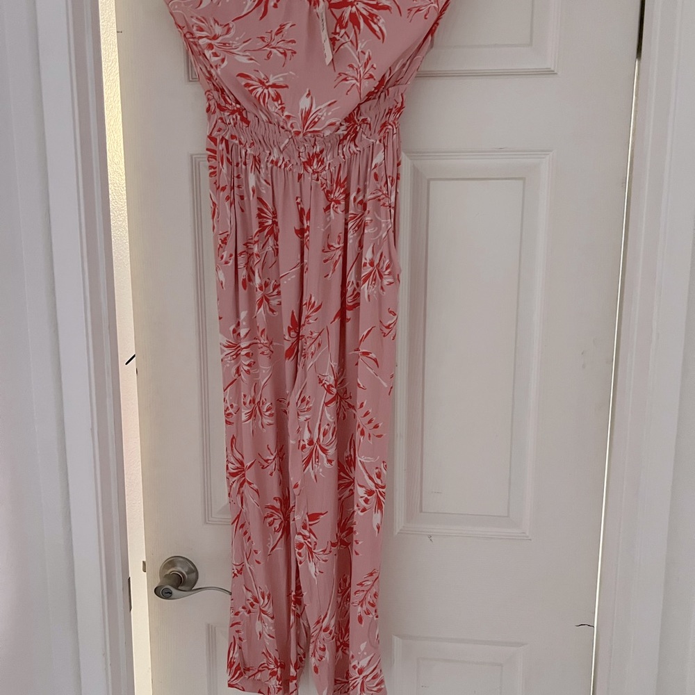 Jumpsuit strapless. Brand new. Never been worn.  Coral pink in size medium.